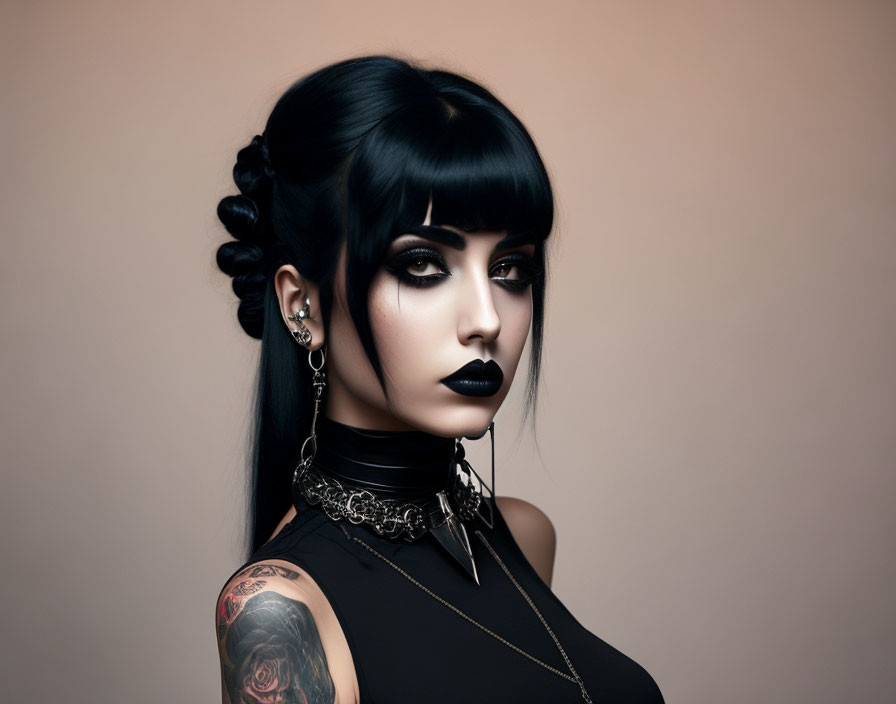 Woman with dark makeup, braided hair, ear piercings, choker, and floral tattoo