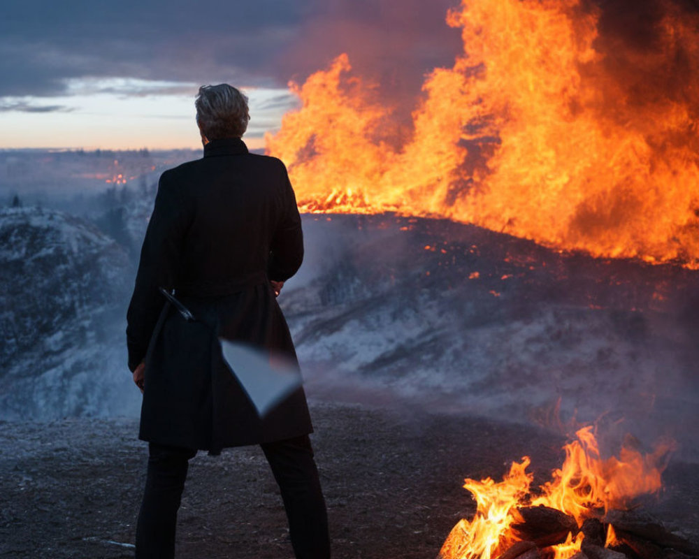 Person in Black Coat with Briefcase Facing Large Fire at Dusk