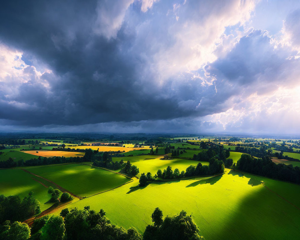 Panoramic view of lush green countryside under dramatic sky