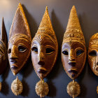 Five Intricately Designed Traditional Wooden Masks with Varying Shapes and Decorative Round Motifs