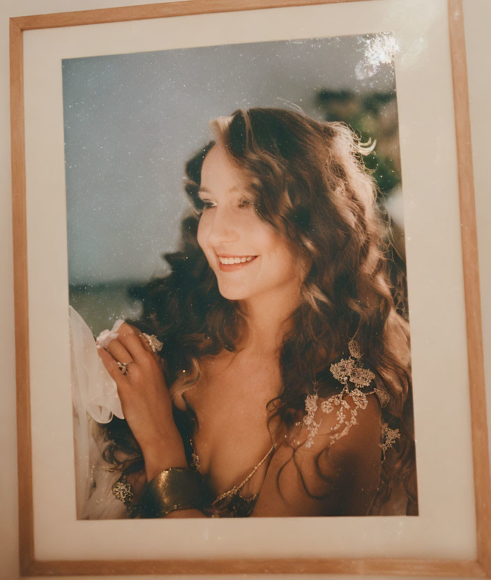 Smiling woman with curly hair in framed photograph