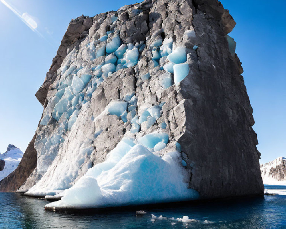 Majestic Iceberg with Blue Ice Formations in Sunny Sky