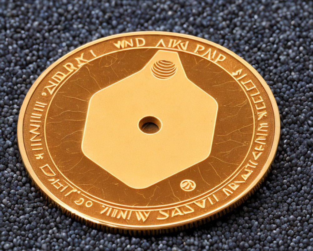 Intricate golden coin with hole on dark textured background