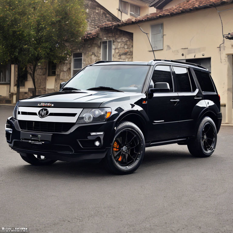 Customized Black SUV with Vented Hood and Custom Rims on Street