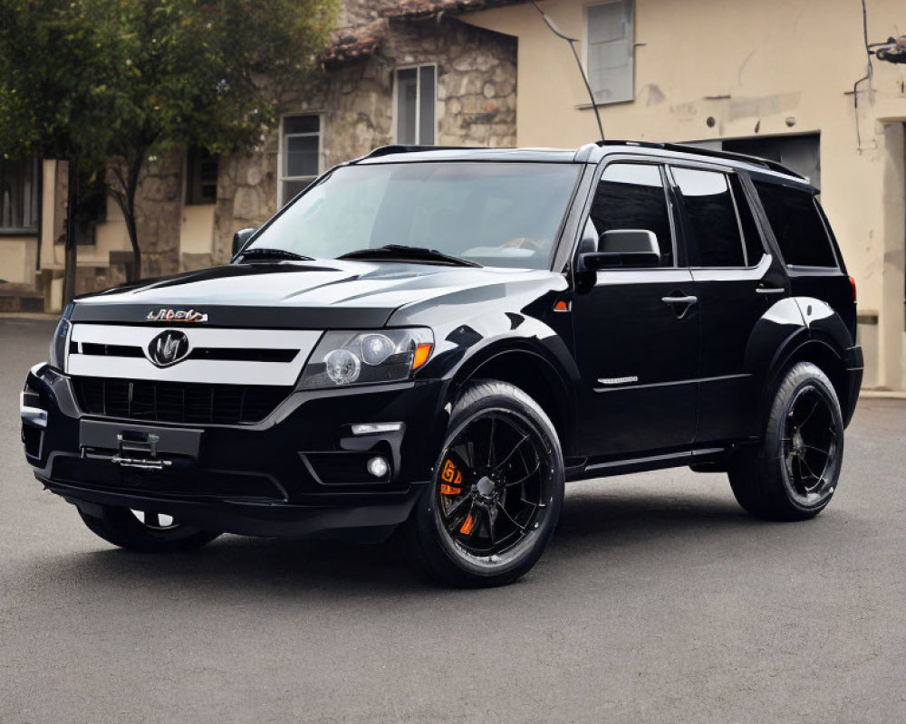 Customized Black SUV with Vented Hood and Custom Rims on Street