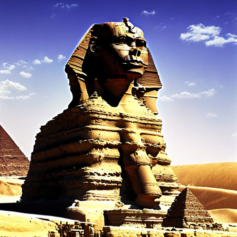 Majestic Sphinx of Giza and pyramid against blue sky