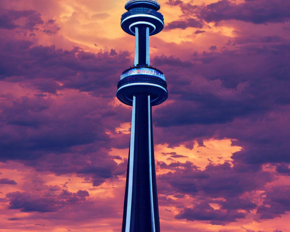 Iconic CN Tower silhouetted against colorful dusk sky with blue edge lights