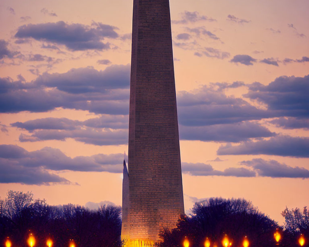 Tall Obelisk Monument at Twilight with Trees and Street Lamps