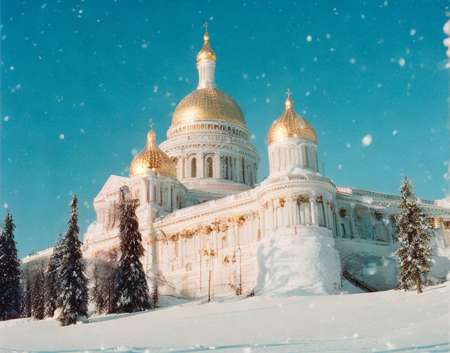 Majestic cathedral with golden domes in snowy landscape