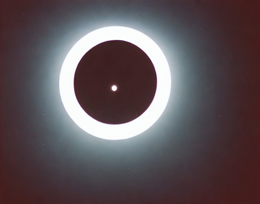 Solar Eclipse Showing Sun's Corona Around Darkened Moon in Dusky Sky
