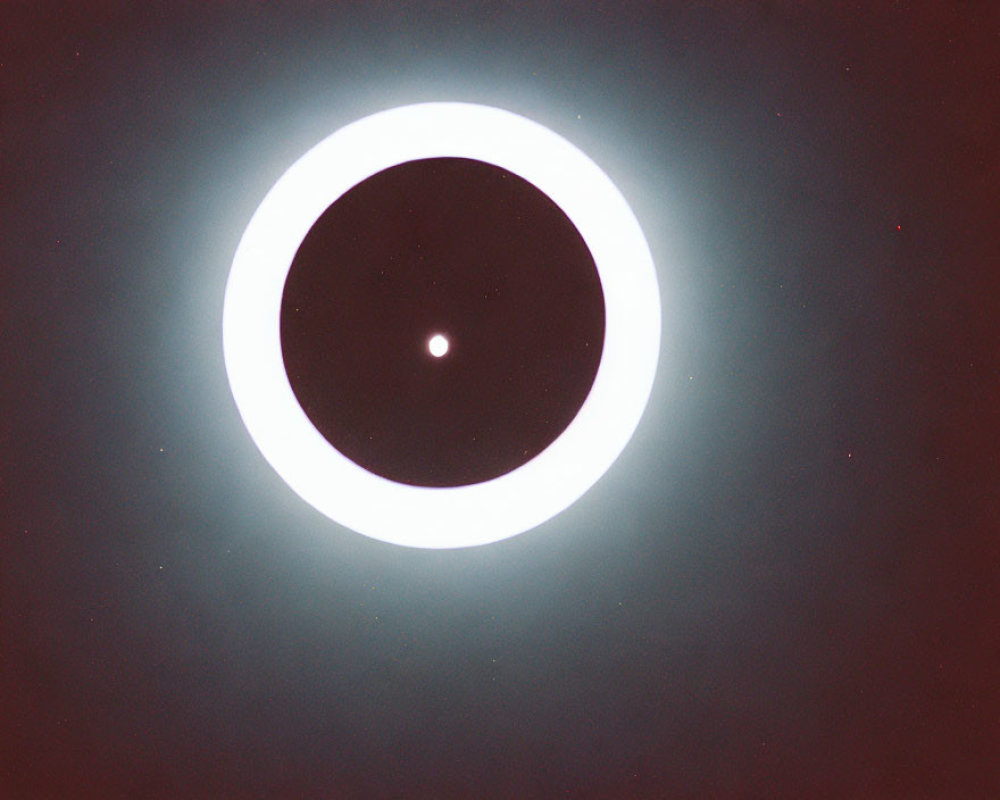 Solar Eclipse Showing Sun's Corona Around Darkened Moon in Dusky Sky