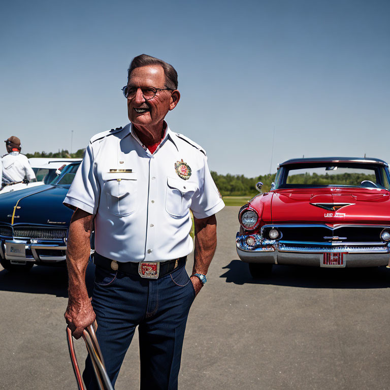 Elderly gentleman in white firefighter uniform with vintage cars and clear blue sky