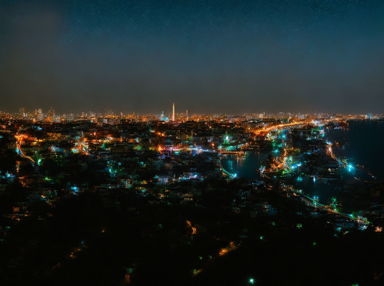 Bright cityscape with star-filled sky over illuminated urban area.