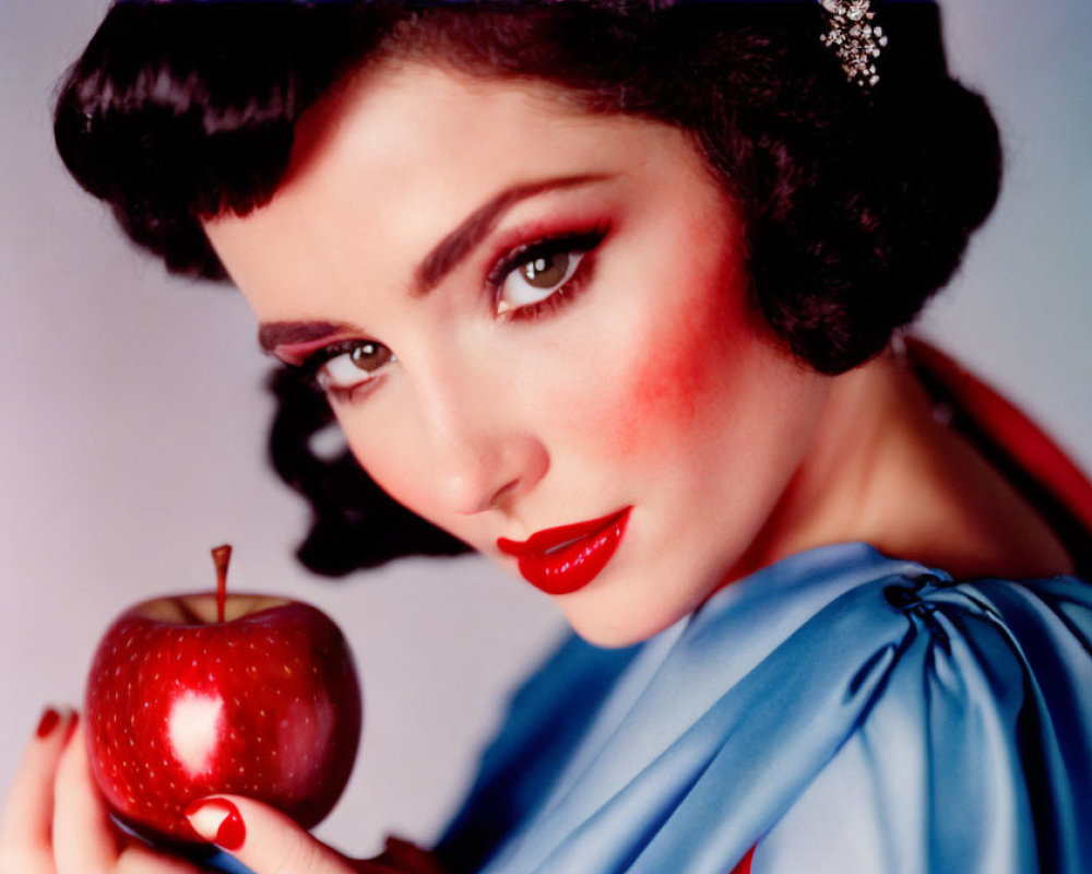 Vintage-Style Portrait of Woman with Dark Hair, Red Lipstick, Holding Red Apple in Blue Out