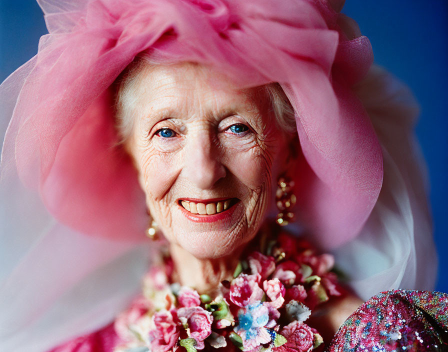 Elderly Lady in Pink Hat with Tulle and Floral Adornments