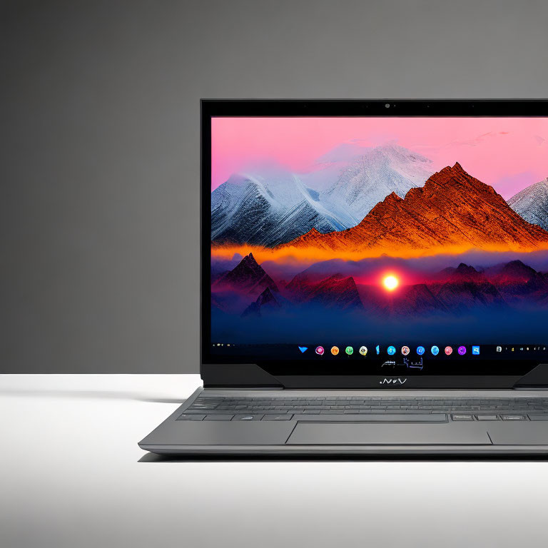 Modern Laptop with Sunset Mountain Wallpaper on White Desk