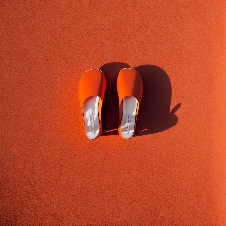Orange Slides on Textured Surface with Sunlight Shadows