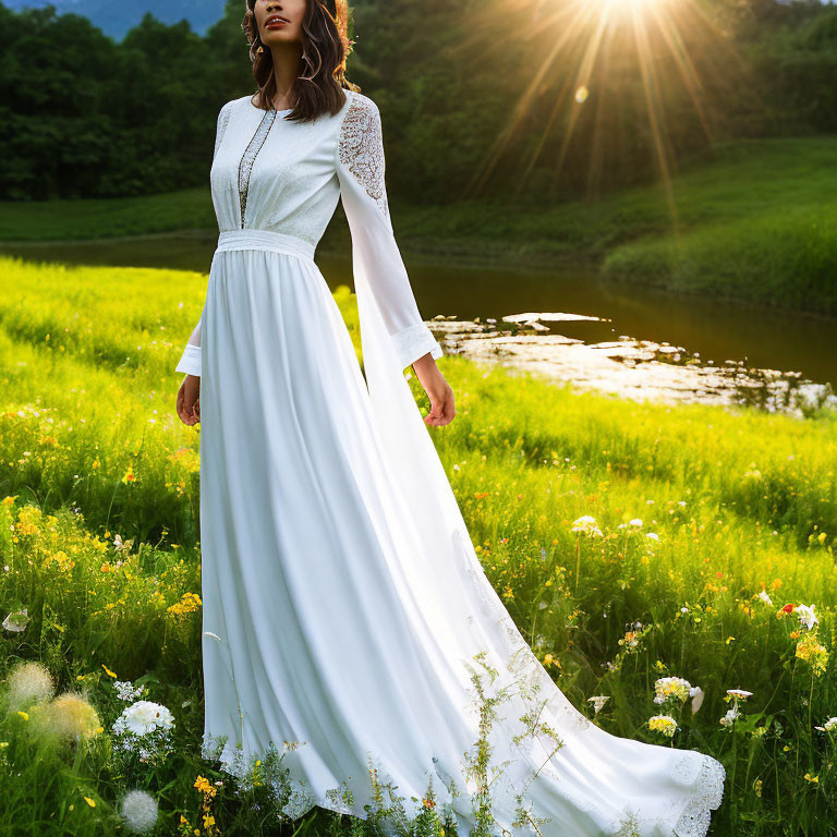 Woman in White Dress Standing in Sunlit Meadow by Pond with Wildflowers