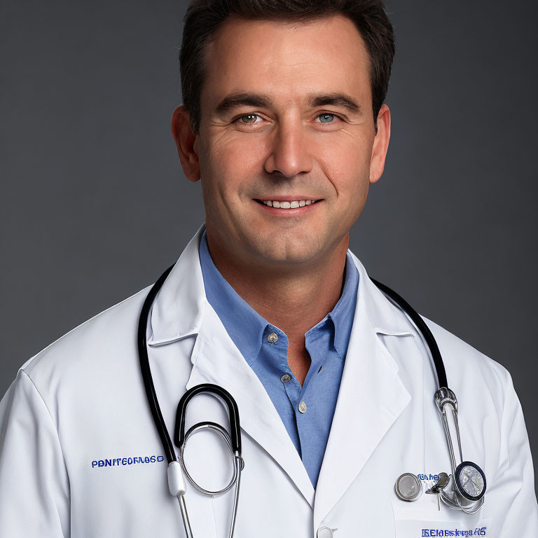 Male healthcare professional in white lab coat with stethoscope on grey background
