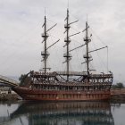 Fantasy-style ornate sailing ship with golden decorations sailing at sea