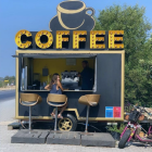 Quirky Coffee Kiosk with Giant Cup Serving Outdoors