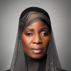 Portrait of person with headscarf, dramatic eye makeup, and sparkling details.
