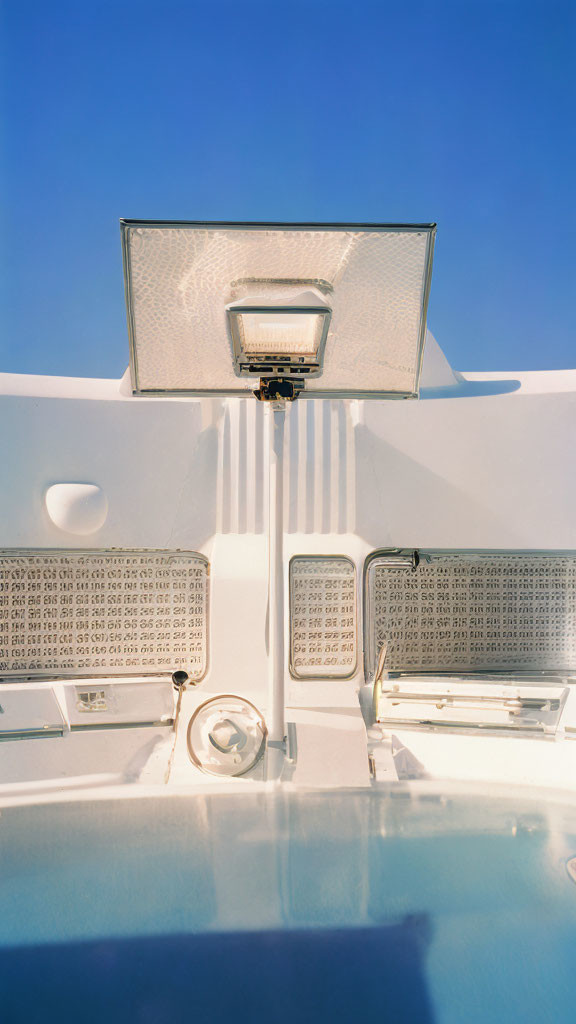 White Car Trunk Open Against Blue Sky: Rear Light and Interior Details