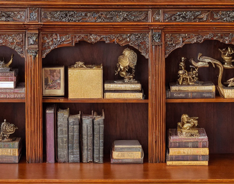 Carved Wooden Bookshelf with Old Books and Golden Figurines