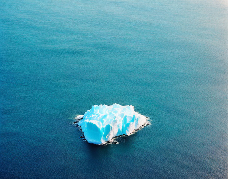Blue iceberg peacefully floating in deep ocean