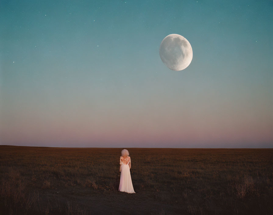 Person in long dress gazes at bright moon in open field at dusk