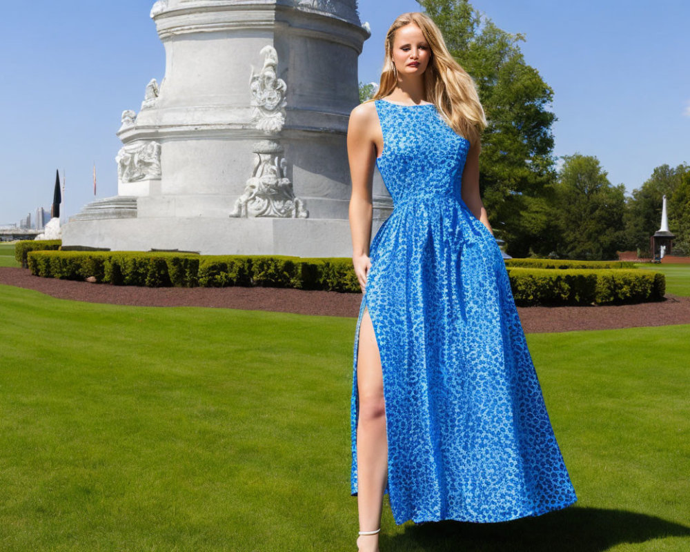 Woman in Blue Sleeveless Dress Poses by Monument Outdoors