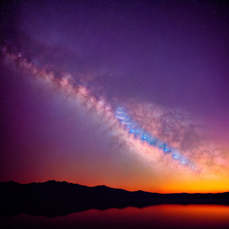 Colorful Milky Way galaxy over silhouette mountains at night