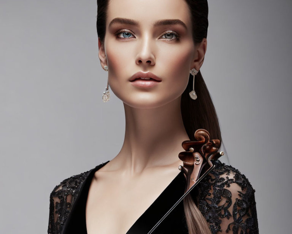 Stylish woman in black lace dress with violin and diamond earrings