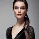 Stylish woman in black lace dress with violin and diamond earrings