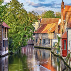 Colorful illustration of idyllic medieval village with canal, boats, and lush greenery
