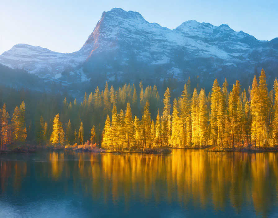 Serene mountain lake at sunrise with golden larch trees and snow-dusted peaks