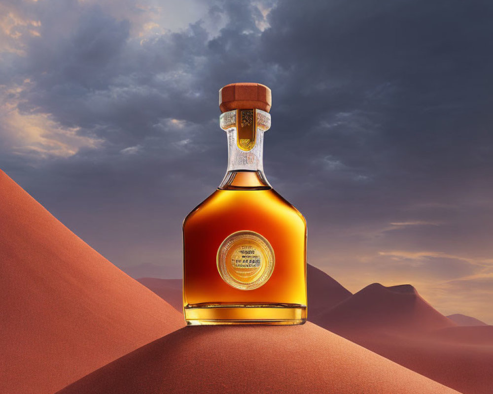 Amber-colored liquor bottle on sand dune with mountains and orange sky