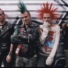 Colorful Mohawk Punk Individuals in Leather Jackets Before Graffiti Wall