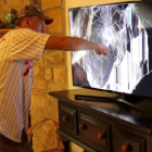 Renaissance man aims gun at TV with lightning bolt, blending eras