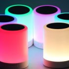 Colorful Neon Cylindrical Lamps on Dark Surface