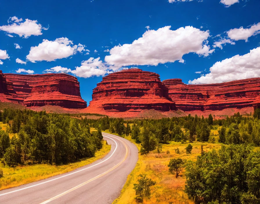 Scenic landscape with red rock formations and winding road