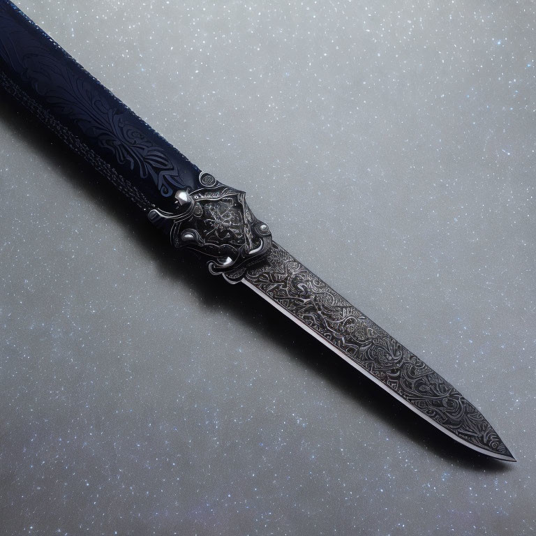 Intricately patterned ornate knife on speckled grey background