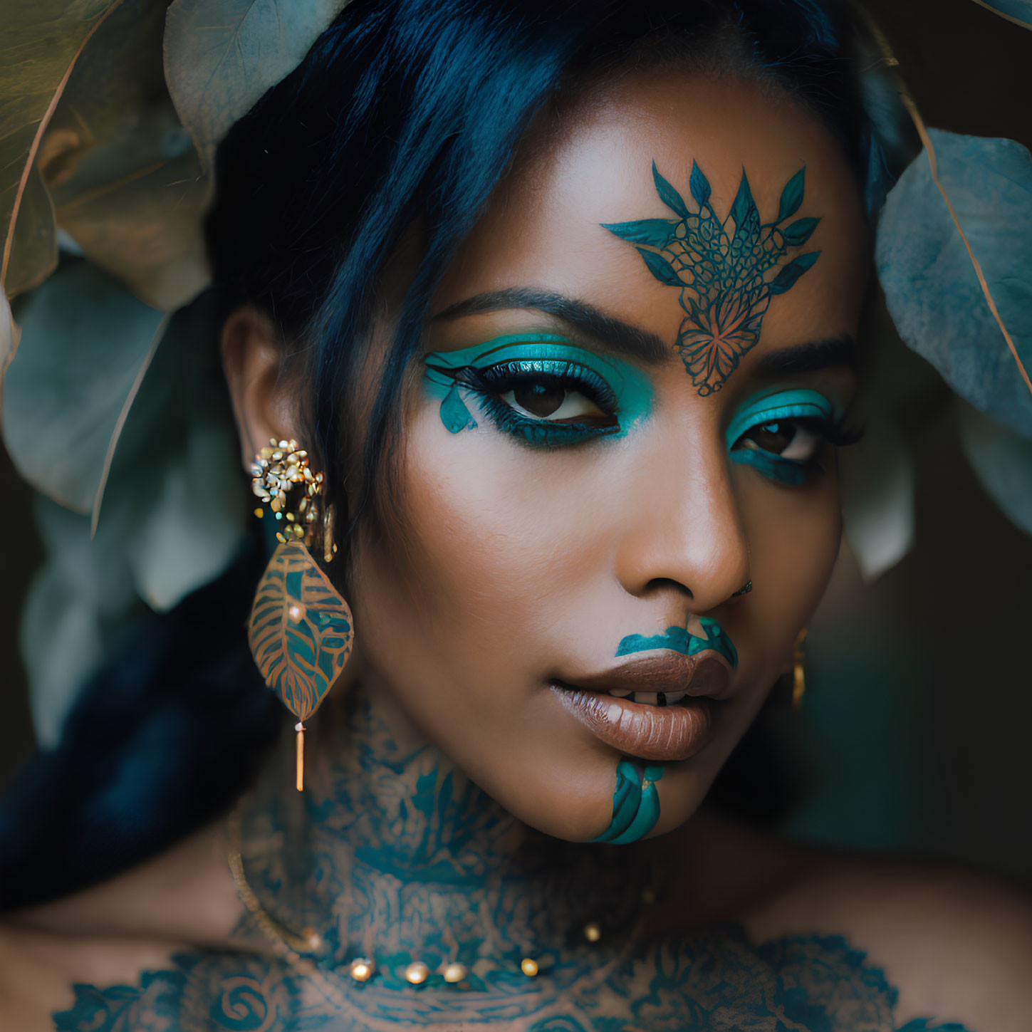 Woman with Blue Makeup, Tattoos, Gold Earrings & Leafy Accessories