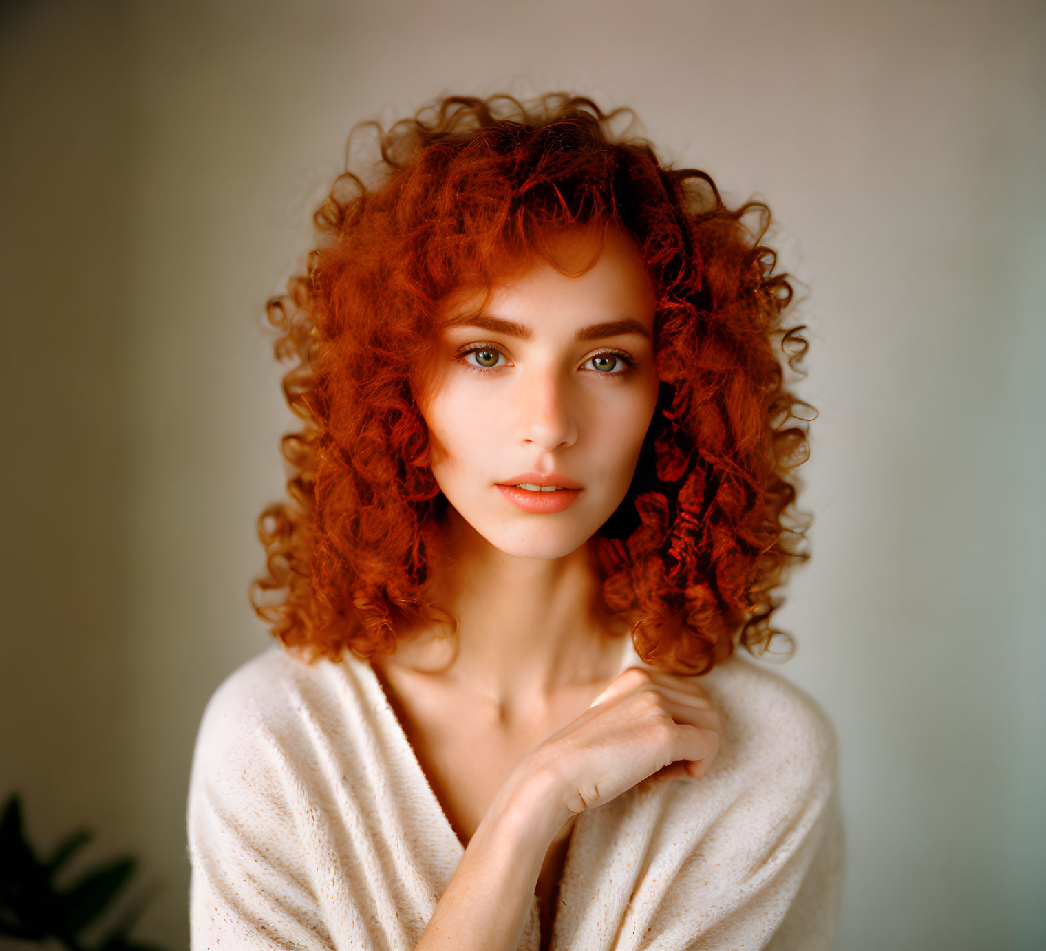 Curly Red-Haired Woman in White Top with Blue Eyes Portrait