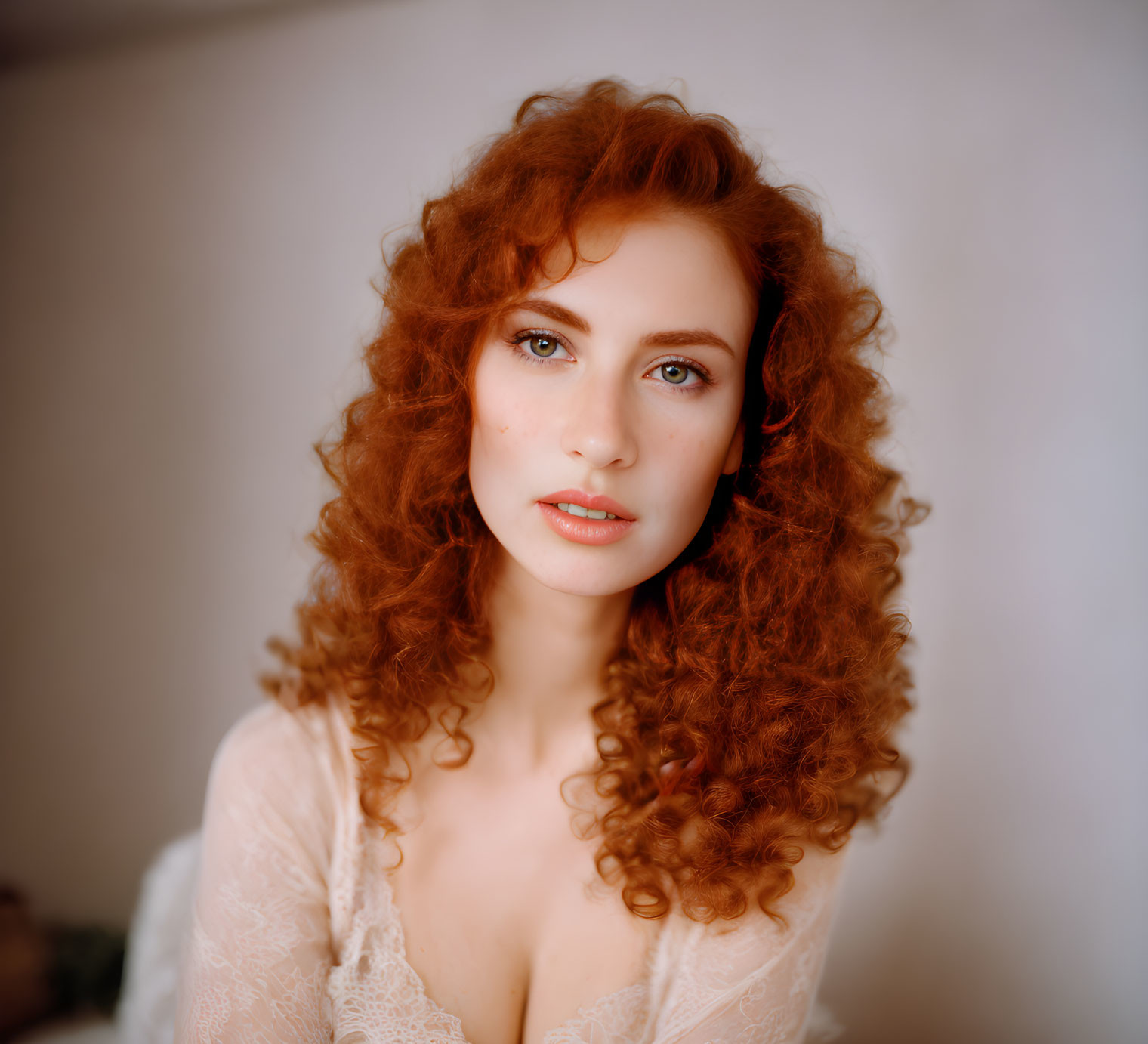 Portrait of woman with curly red hair and lace garment