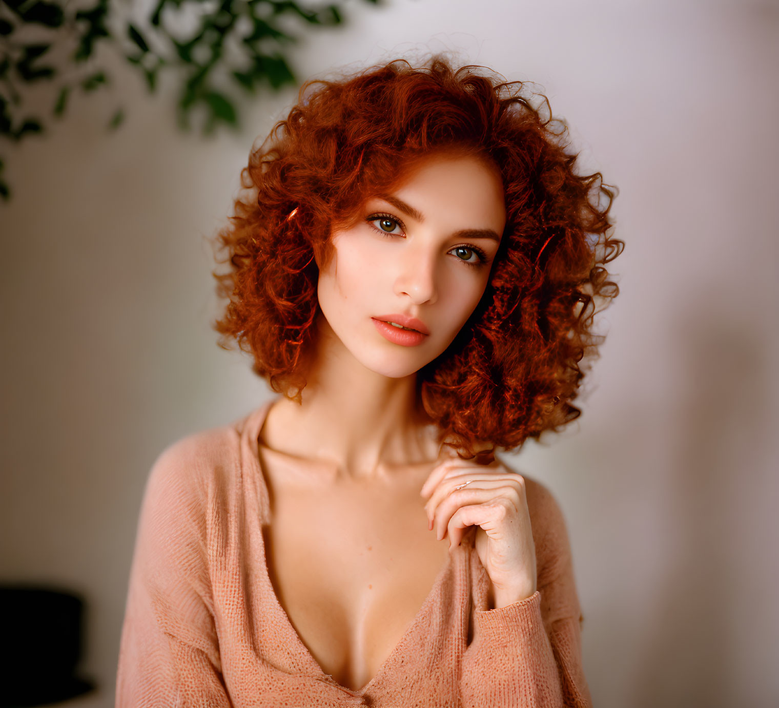 Portrait of Woman with Curly Red Hair and Blue Eyes in Light Pink Blouse