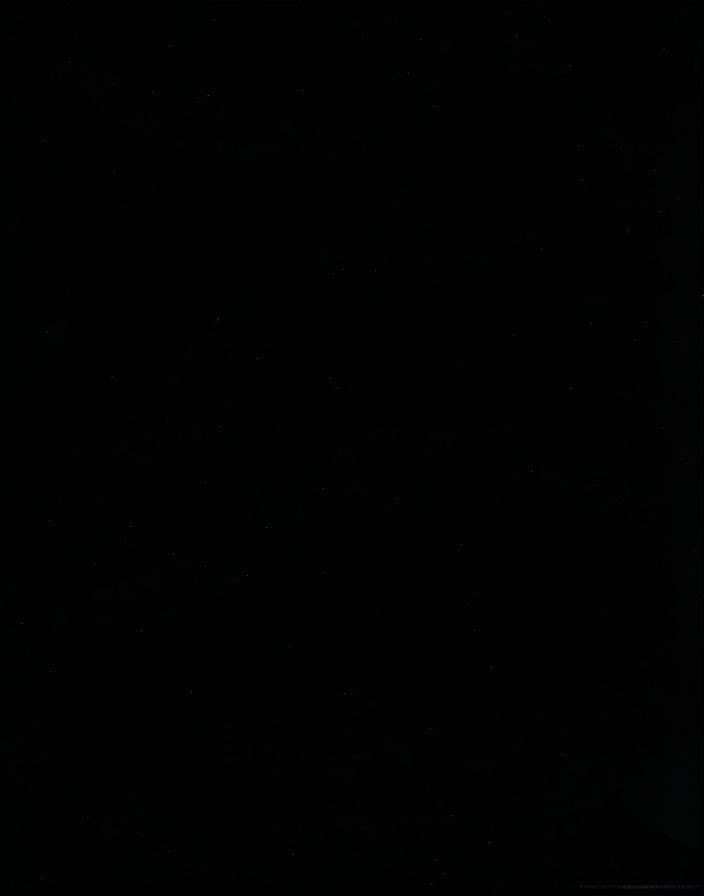 Nearly Black Image with Minor Light Spots Depicting Dark Scene