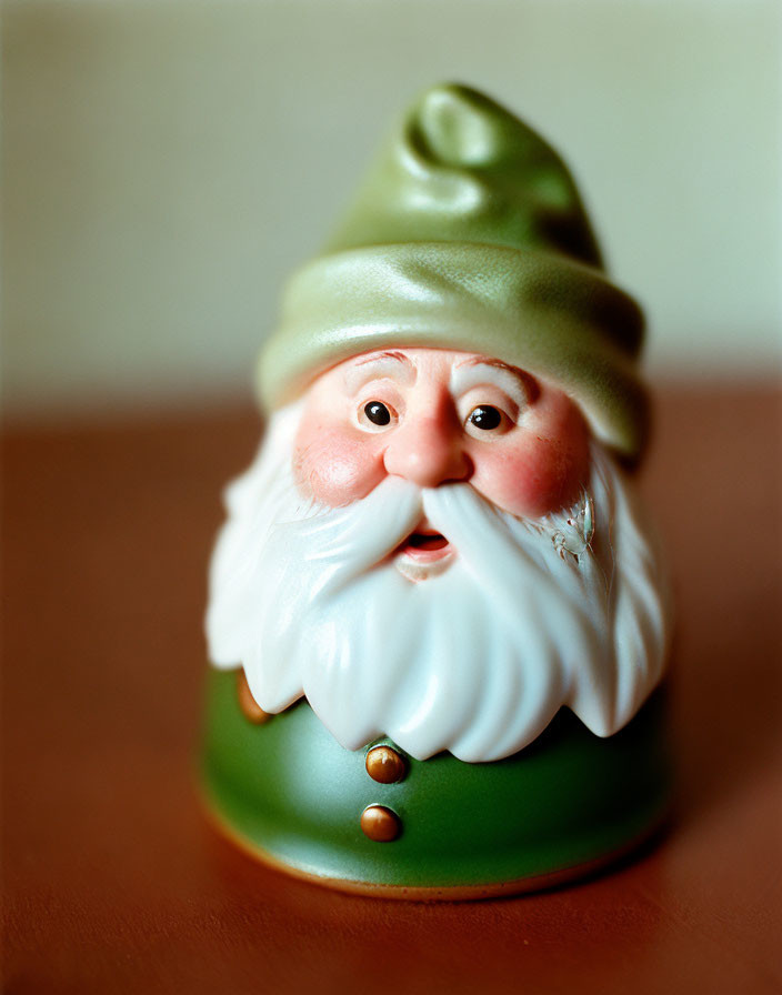 Close-up of gnome figurine with green hat, white beard, and rosy cheeks