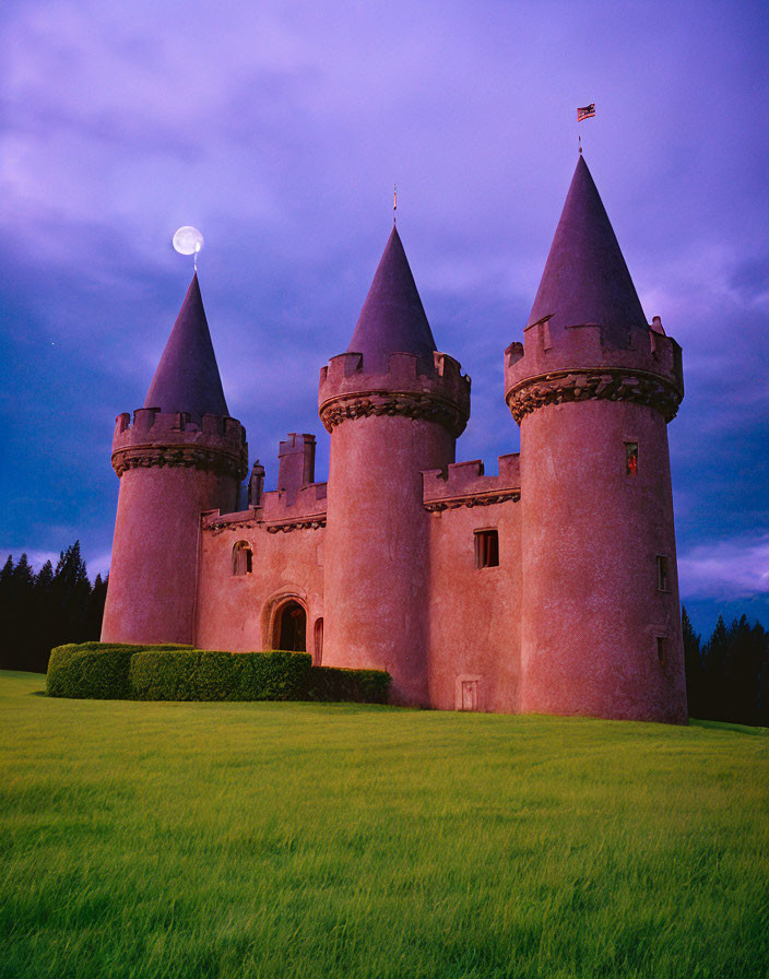 Pink-toned castle with conical towers under full moon