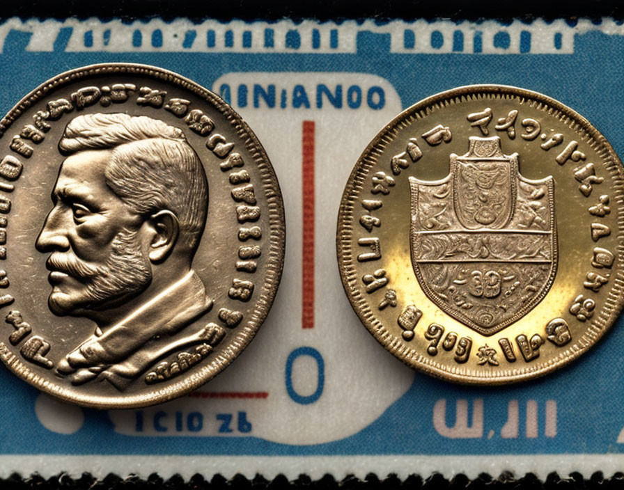 Detailed close-up of two embossed coins with faces and crests on a ruled background.